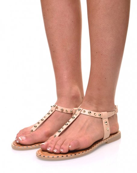 Bare beige feet studded with gold