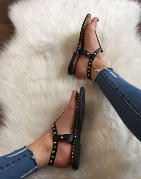 Bare black feet studded with gold