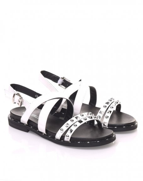 Bare feet with white studded straps