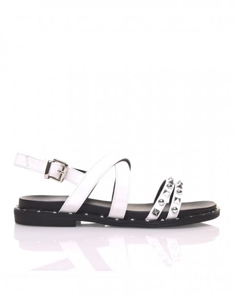 Bare feet with white studded straps