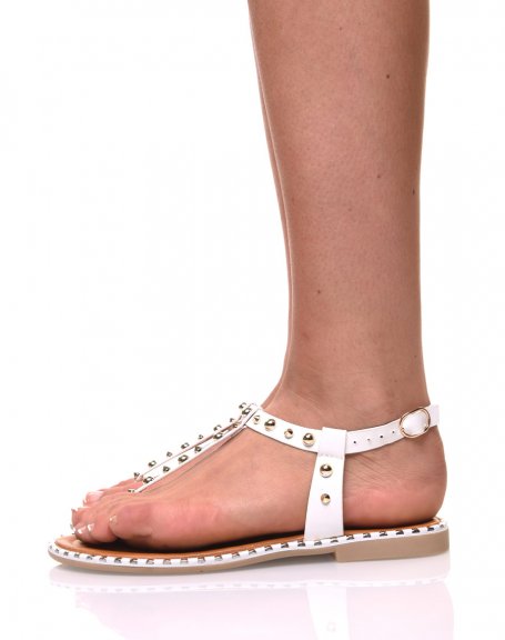 Bare white feet studded with gold
