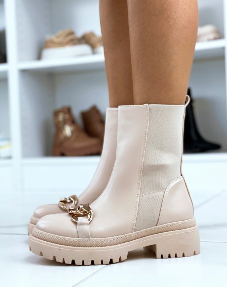 Beige ankle boots adorned with a golden chain