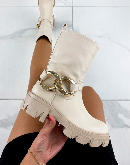 Beige ankle boots with large golden chain and notched sole
