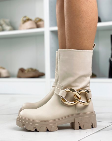 Beige ankle boots with large golden chain and notched sole