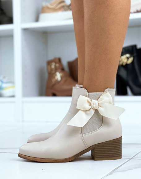 Beige faux leather ankle boots with integrated bow