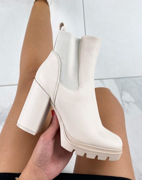 Beige heeled ankle boots with notched platform
