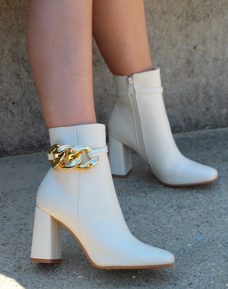 Beige heeled ankle boots with square toe and golden chain