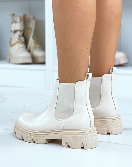 Beige heeled chelsea boots with notched sole