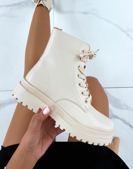 Beige lace-up ankle boots with a notched flat sole
