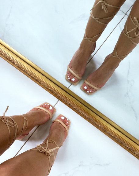 Beige lace-up sandals with a thin heel strap