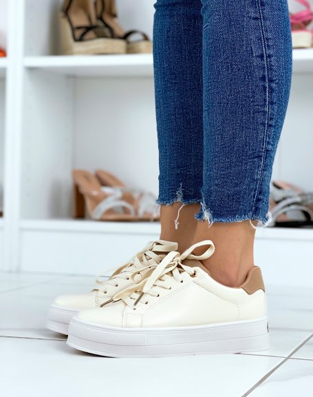 Beige low-top sneakers with brown yoke and thick sole