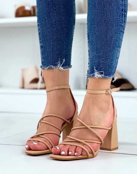 Beige sandals with criss-cross straps and thick heel