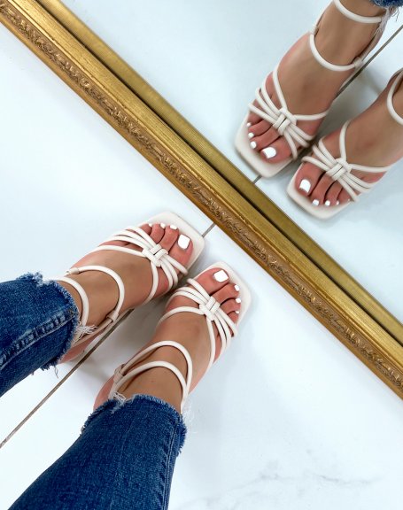Beige sandals with high straps and tied heel
