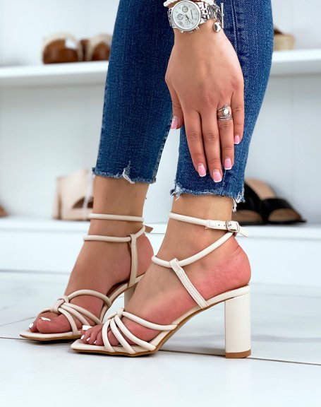 Beige sandals with high straps and tied heel