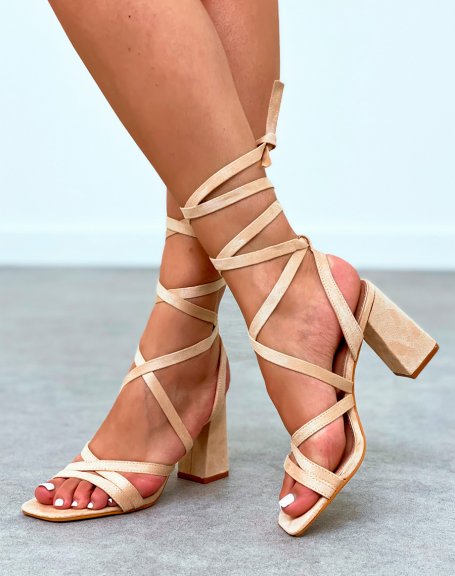 Beige sandals with narrow straps crossed with lace and heel