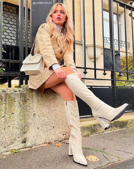 Beige sock-style boots with heel and pointed toe with silver detail