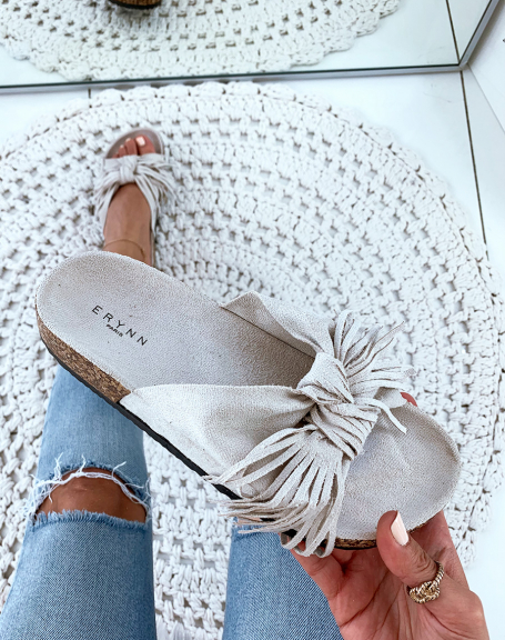 Beige suede mules with wide knotted straps and fringes