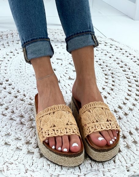 Beige wicker mules with woven patterns and platform