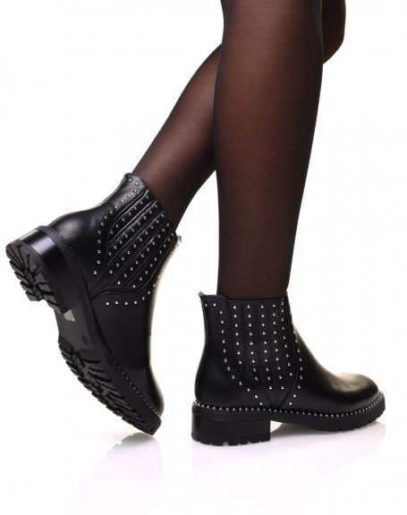 Black ankle boots adorned with small studs on the sides