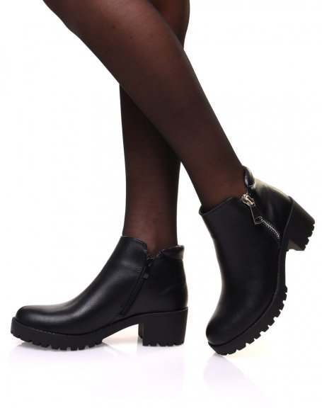 Black ankle boots with decorative zipper and mid-high heel