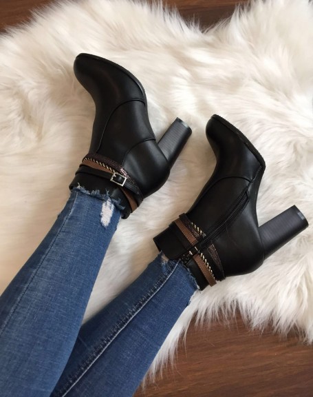 Black ankle boots with high heels and decorative straps