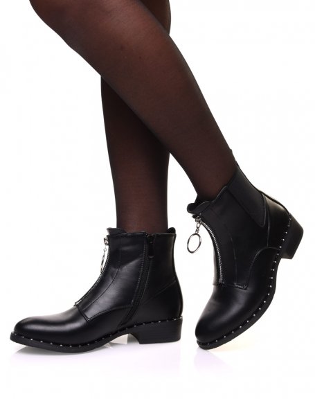 Black ankle boots with studded sole and decorative zipper at the front