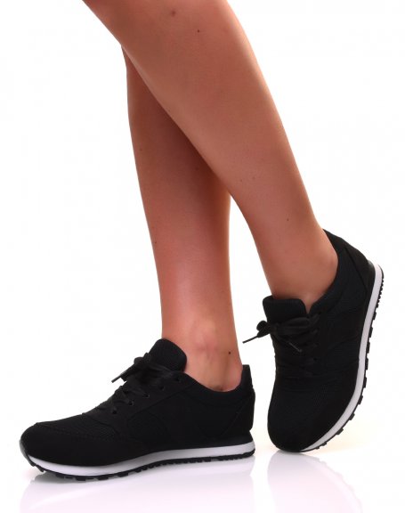 Black canvas sneakers with laces and white sole