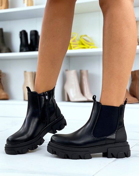 Black Chelsea boots adorned with a rubber insert