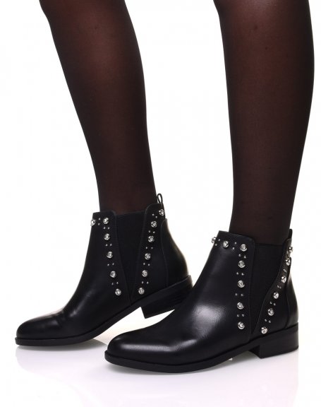Black Chelsea boots adorned with rhinestones