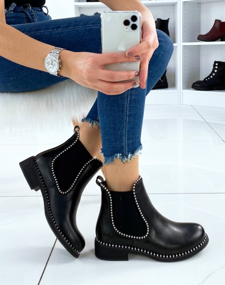 Black Chelsea boots adorned with silver pearls