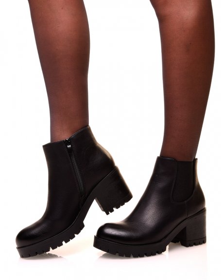 Black Chelsea boots with notched soles