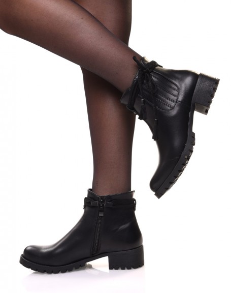 Black Chelsea boots with straps and pompoms