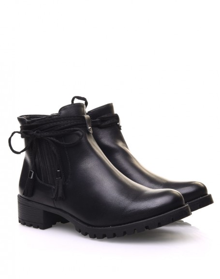 Black Chelsea boots with straps and pompoms