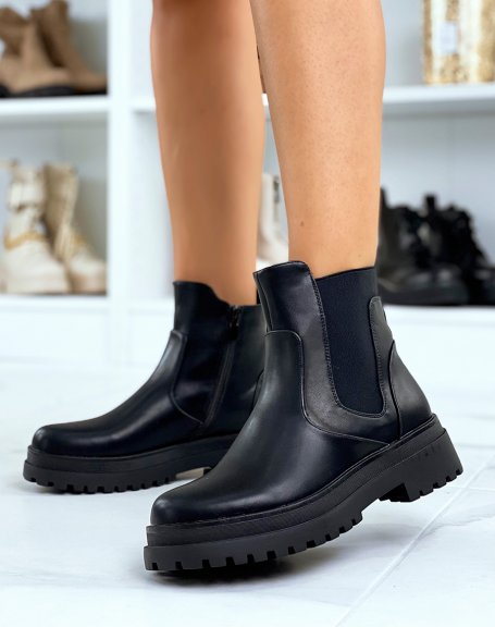 Black Chelsea-inspired boots with inserts and a flat lugged sole