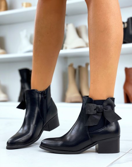Black faux leather ankle boots with integrated bow