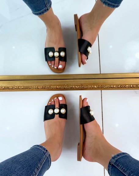 Black flat mules adorned with chunky pearls