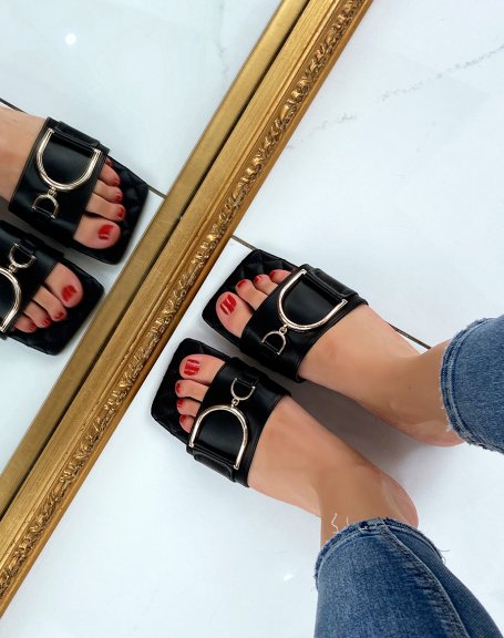Black flat mules with asymmetric gold detail