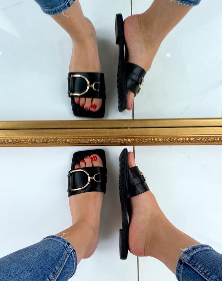 Black flat mules with asymmetric gold detail