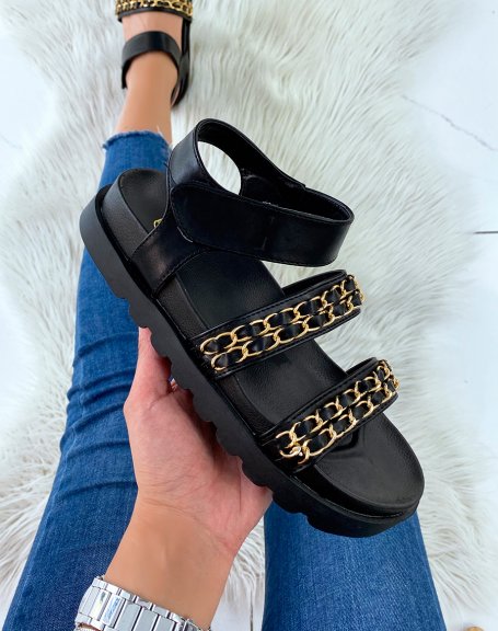Black flat sandals with chunky straps and gold chains