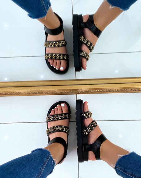 Black flat sandals with chunky straps and gold chains