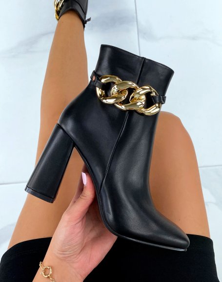 Black heeled ankle boots with square toe and gold chain