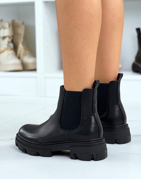 Black heeled chelsea boots with notched sole