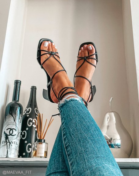 Black heeled sandals with crisscrossed laces