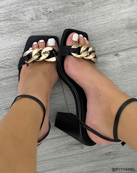 Black heeled sandals with thin straps and gold chain