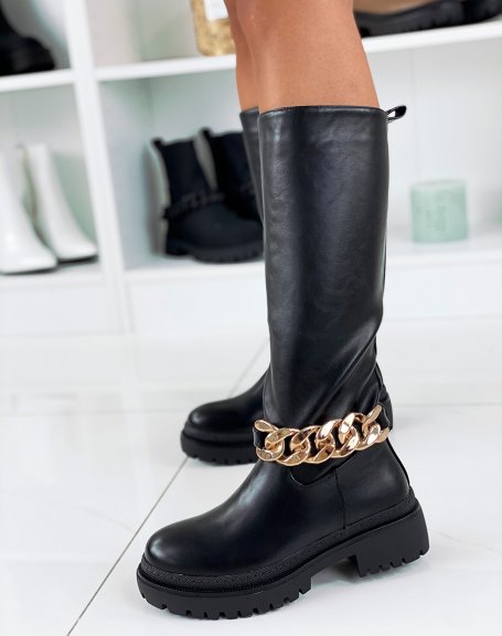 Black high boots adorned with a golden chain