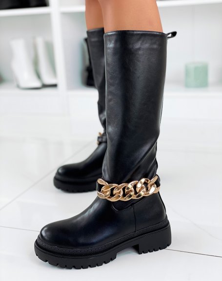 Black high boots adorned with a golden chain
