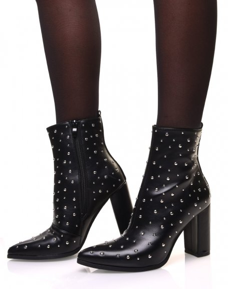 Black high heel ankle boots adorned with round studs
