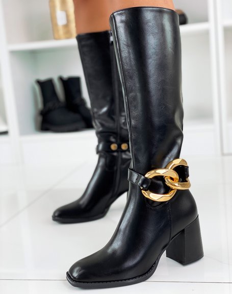 Black high heeled boots adorned with a gold chain