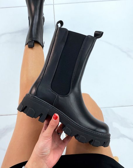 Black high top Chelsea boots with notched sole