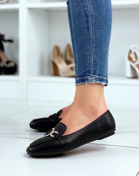 Black loafers with asymmetrical golden rhinestone buckles